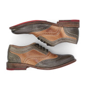 A pair of green and tan wingtip oxford shoes, the Lita by Bed Stu.