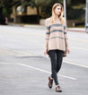 A woman wearing Bed Stu Lita shoes, ripped jeans and a sweater.