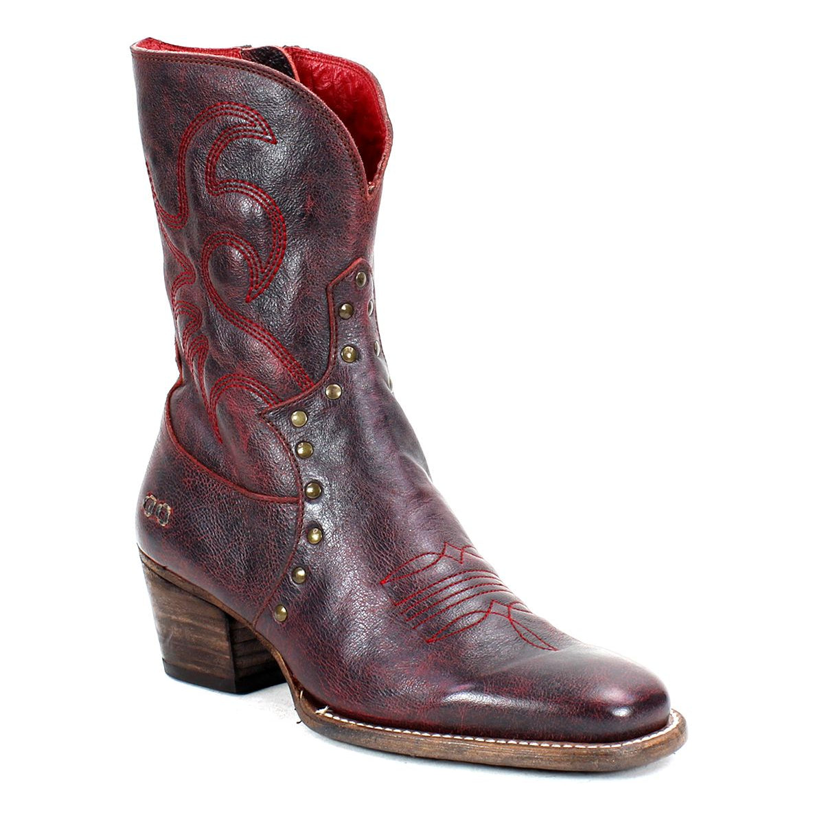 Bed Stu's "Locate" boots are crafted from brown leather and designed with flame-like stitching, metal studs, and feature a wooden heel.