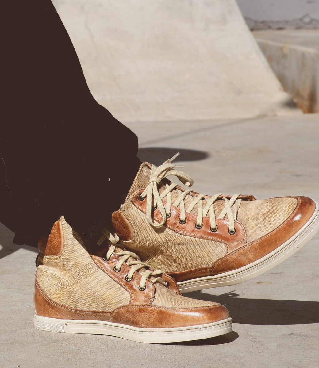 A person wearing a pair of Lordmind sneakers on a skateboard. (Brand: Bed Stu)