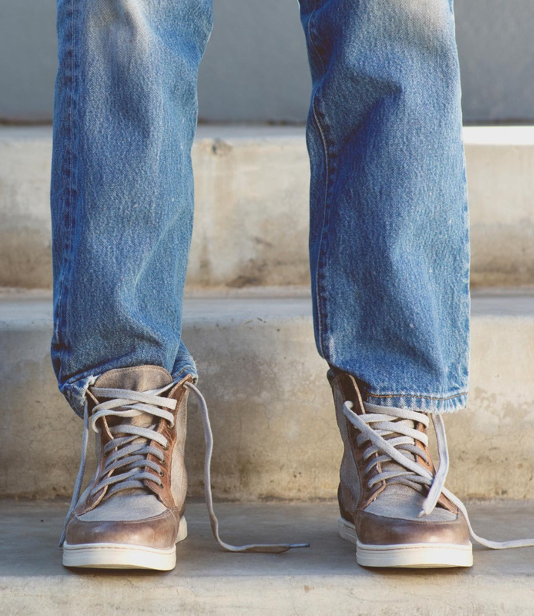 A man's feet standing on a set of Bed Stu Lordmind steps.