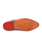 A pair of Loretta shoes by Bed Stu with a red sole.