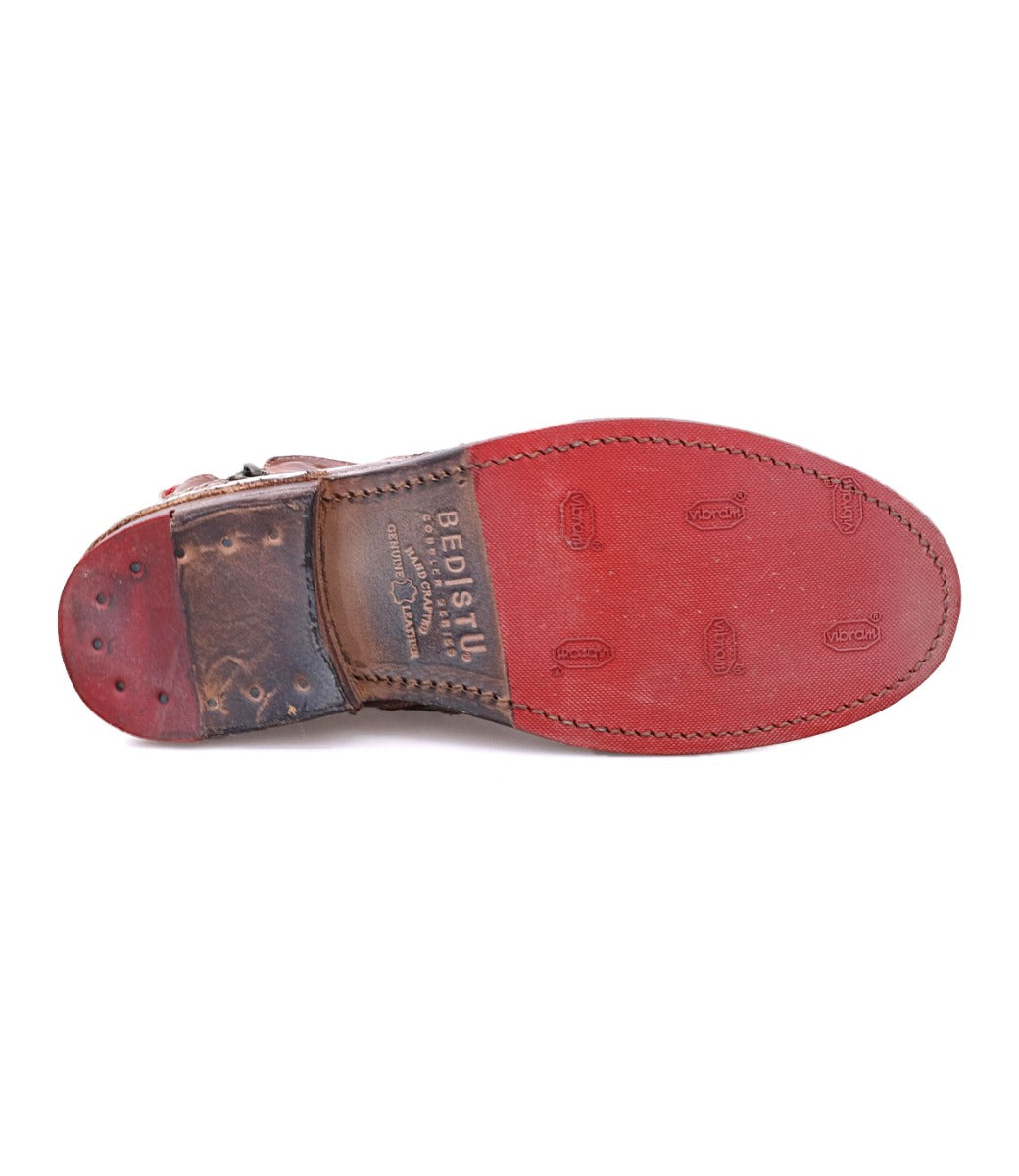 A pair of Lotus shoes with a red leather sole by Bed Stu.