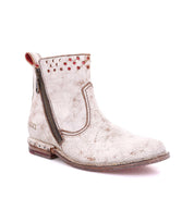 A women's white ankle boot with a zipper on the side, Lotus by Bed Stu.