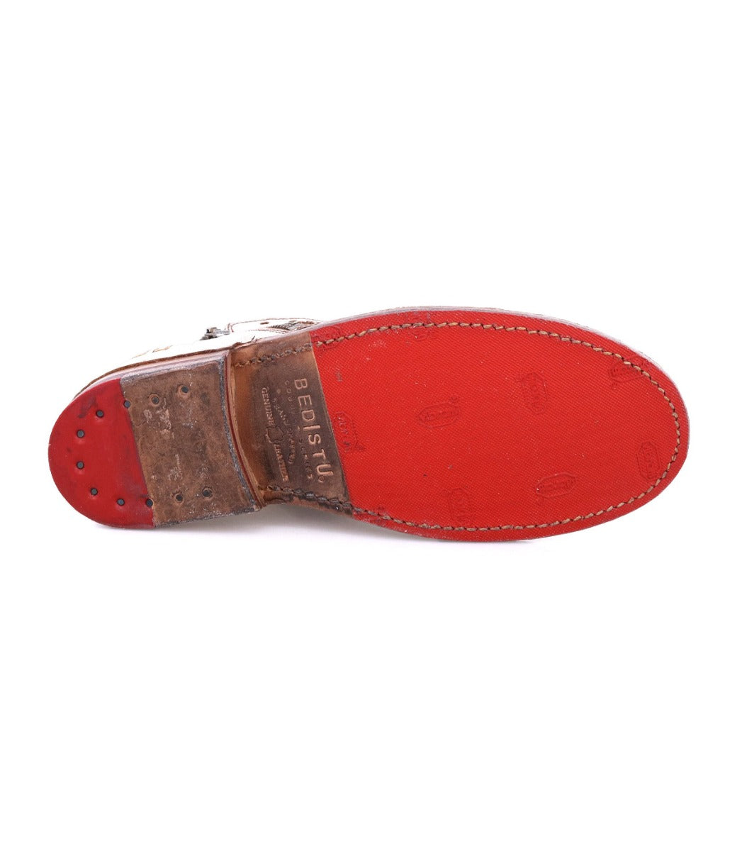 A pair of Lotus shoes with red soles on a white background by Bed Stu.