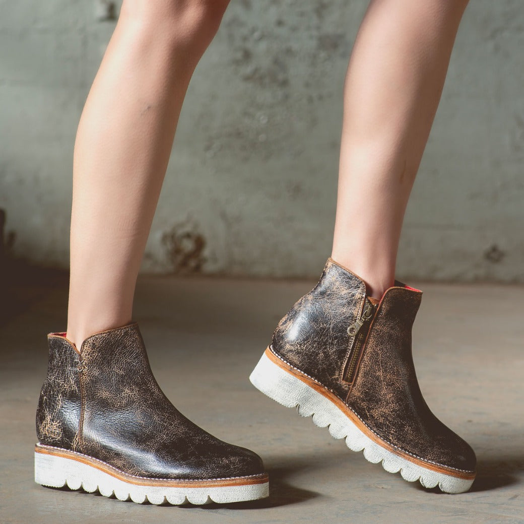 A woman in a pair of Bed Stu Lydyi black leather boots.