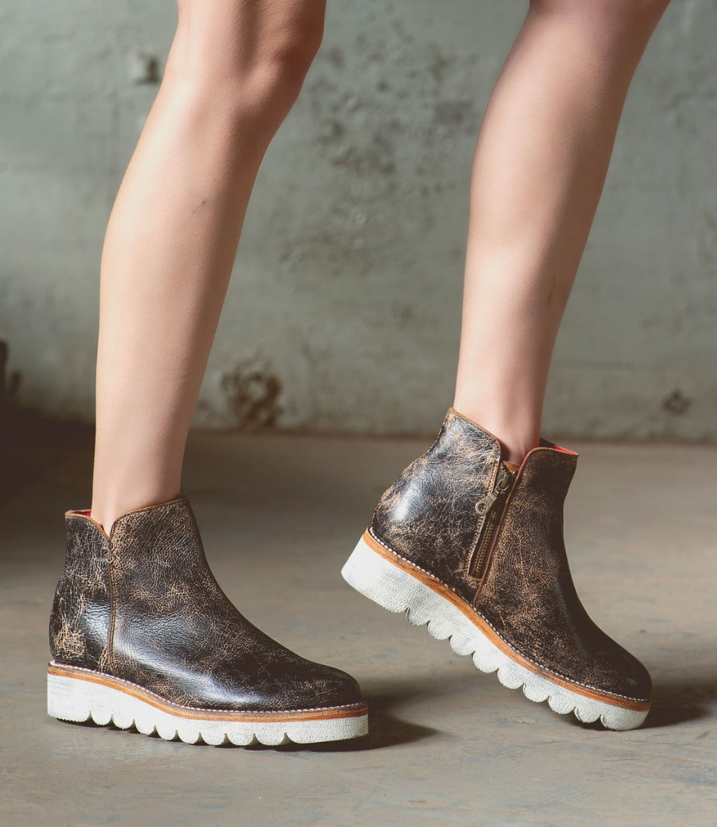 A woman in a pair of Bed Stu Lydyi black leather boots.