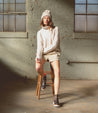 A woman sitting on a stool wearing Bed Stu Lydyi leather boots.