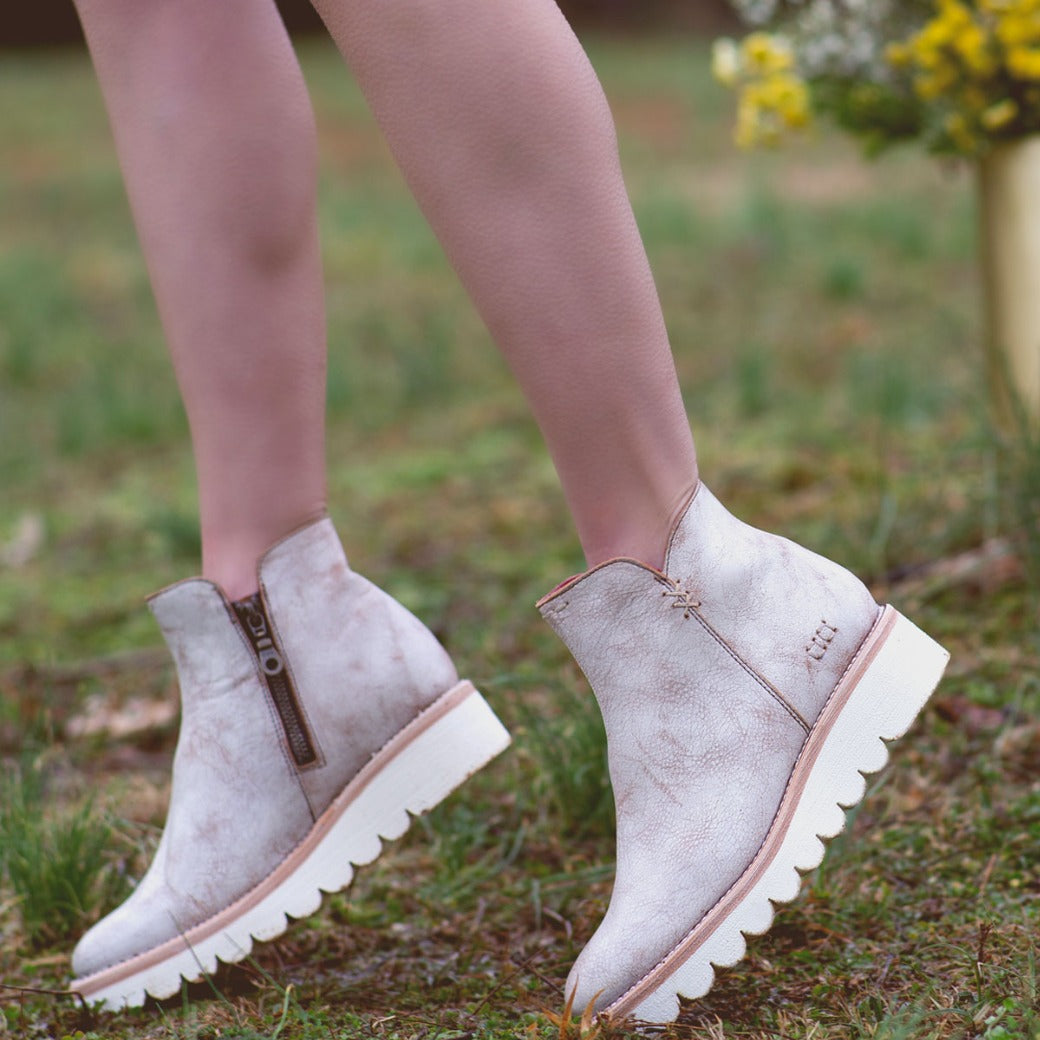 A woman in a pair of Bed Stu Lydyi ankle boots.