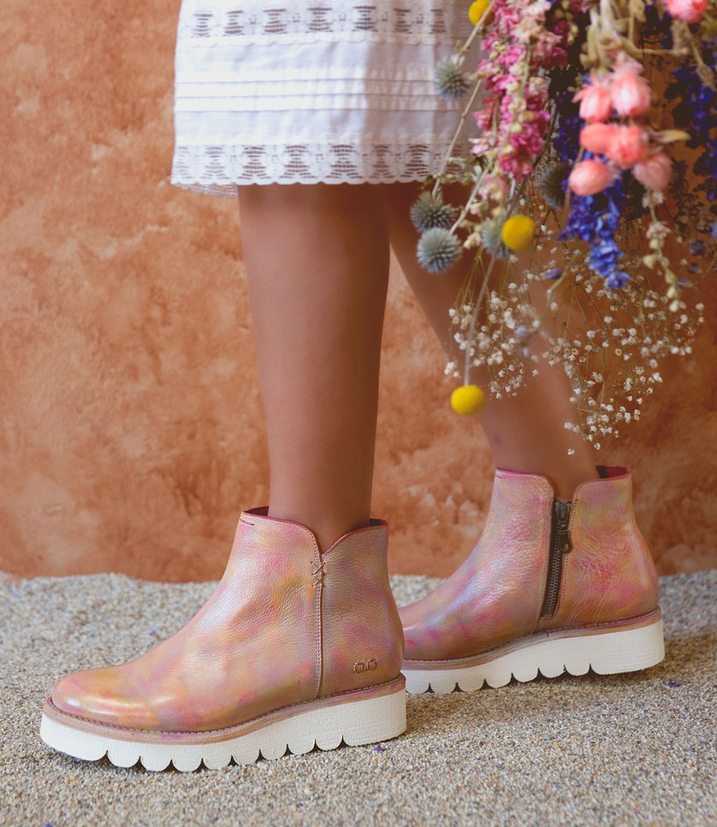 A woman wearing Bed Stu pink Lydyi boots.