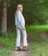 A woman in a white jacket wearing Lydyi boots.