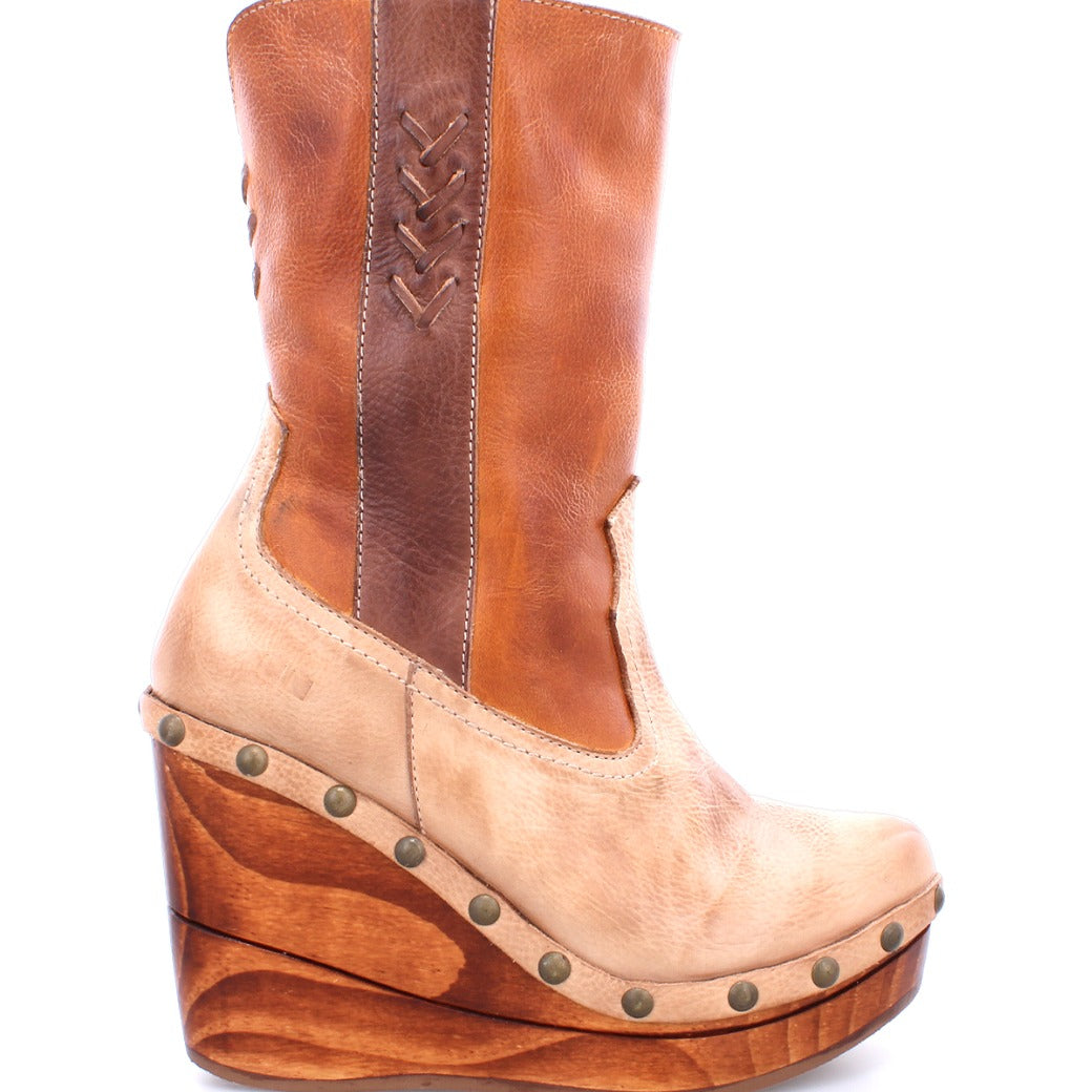 Bed|Stü Macarena two-tone color block leather mid-calf boot on a wooden wedge platform with metal stud detailing and a cushioned insole.