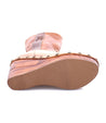 A pair of Macarena women's boots with a tan sole made by Bed Stu.