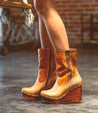 A woman wearing a pair of Bed Stu Macarena boots.