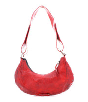 Introducing the Madre by Bed Stu, a red leather shoulder bag with a rock 'n' roll vibe, highlighted by its curved shape and bold metal studs along the edges.