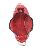 Top view of an open Madre handbag by Bed Stu in red leather, exuding a rock 'n' roll edge, showcasing its visible interior and metal buckle details.