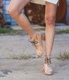 Close up of woman in a pair of tan Bed Stu Mage boots.