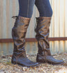 A woman's legs in a pair of Bed Stu Manchester III brown leather boots.