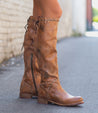 A woman wearing Bed Stu Manchester III boots on a sidewalk.