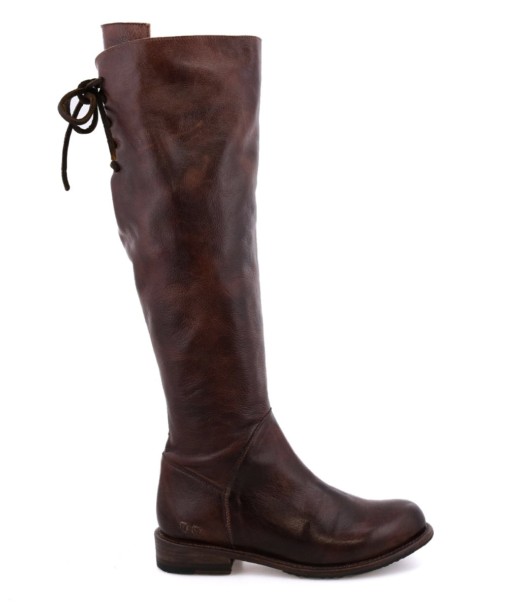 The Bed|Stü Manchester is a tall brown leather boot featuring a comfortable flat heel and a lace tie at the back, shown in side profile on a white background—this modern classic blends timeless style with everyday comfort.