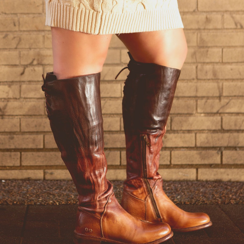 A woman wearing the Bed Stu Manchester Wide Calf boots and a sweater.