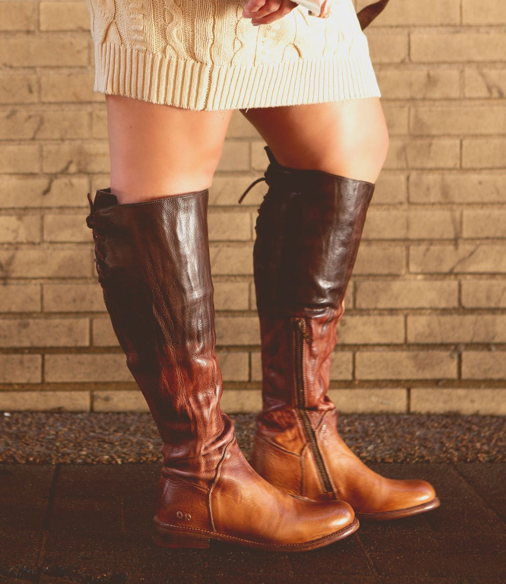 A woman wearing the Bed Stu Manchester Wide Calf boots and a sweater.