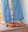 A woman wearing a pair of Bed Stu Mantis jeans and sandals.