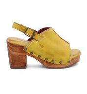 A women's yellow sandal with wooden heel.