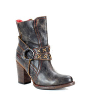 A black distressed leather boot with a high heel, red stitching and o-ring harness on the 45 degree view. 
