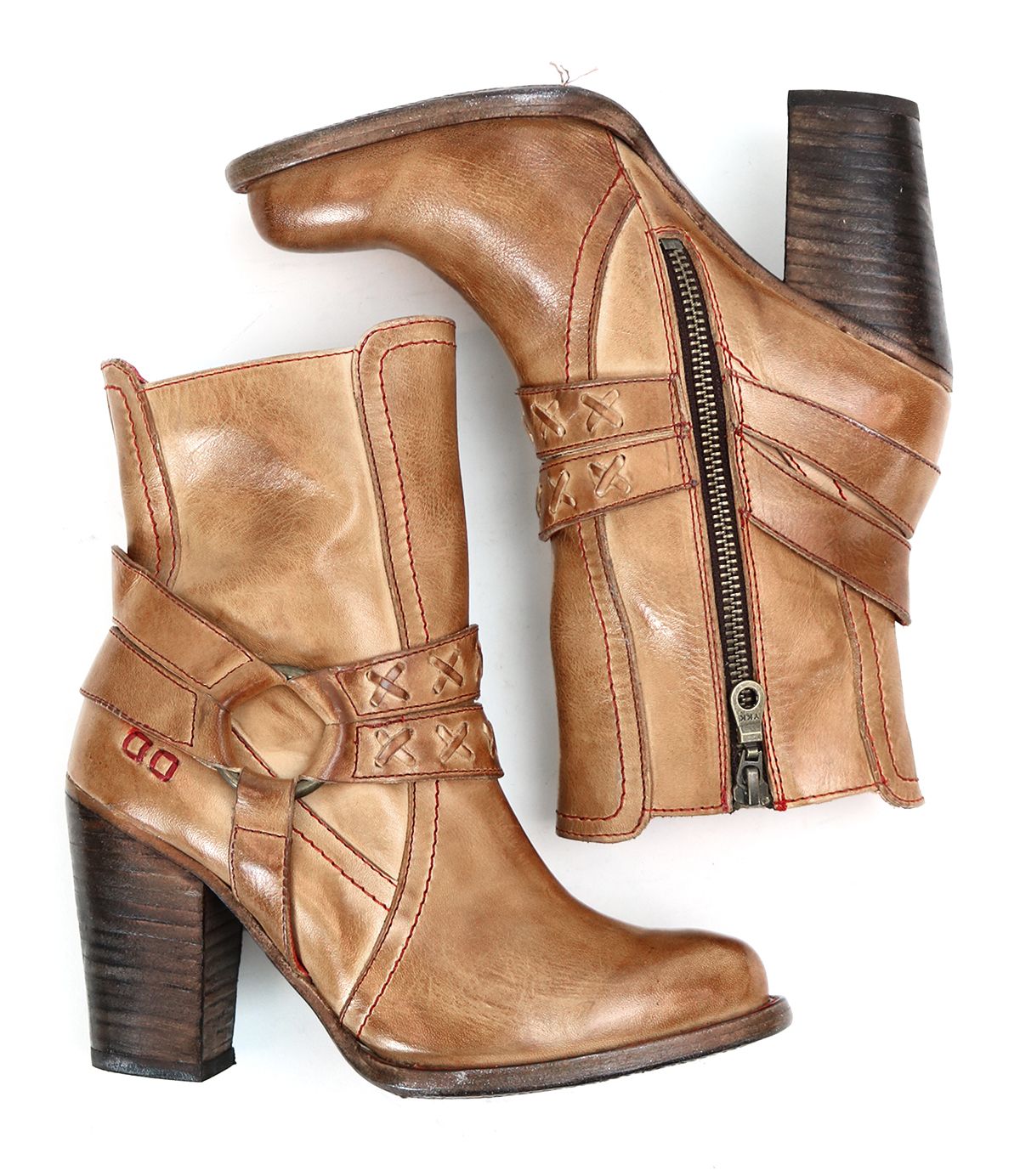 A brown leather heeled pair of boots with o-ring harness, red stitching accents on the profile view. 