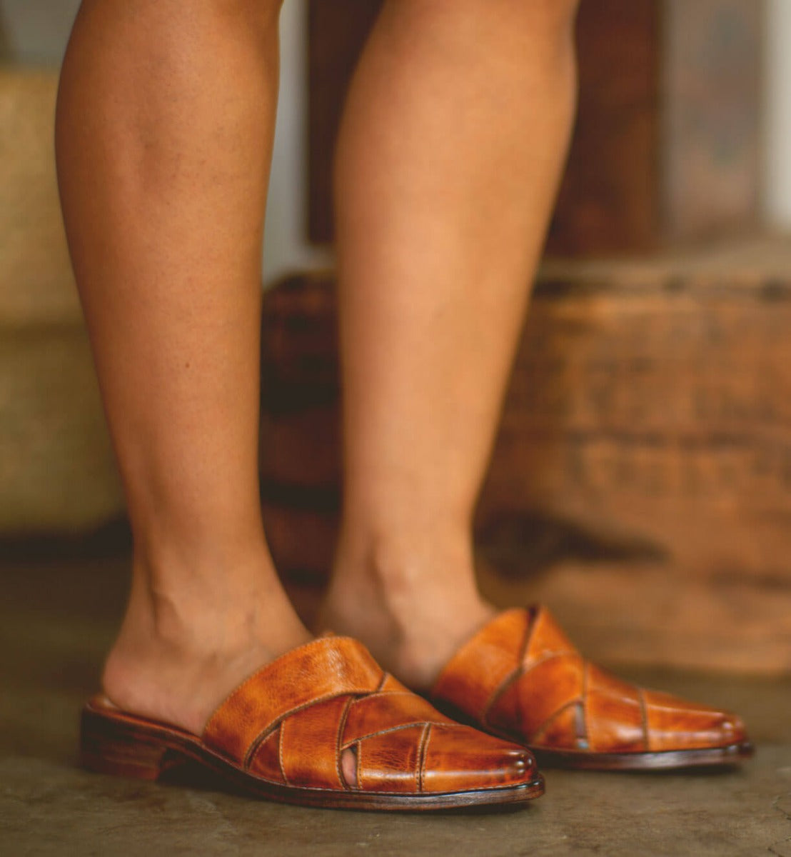 A woman wearing a pair of Bed Stu Mayra brown leather sandals.