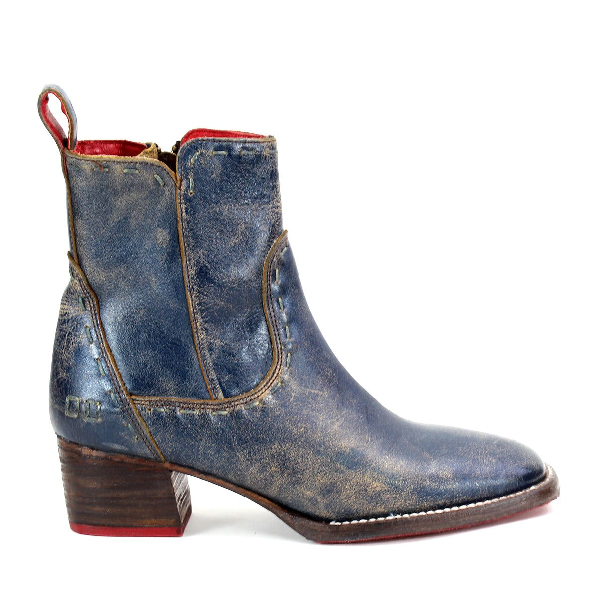 The Merryli by Bed Stu is a stylish blue leather ankle boot featuring a brown stacked heel, red interior lining, and a cushioned insole for all-day comfort.