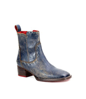 The Bed Stu Merryli is a single blue leather ankle boot featuring a thick heel, red accents, and a cushioned insole.
