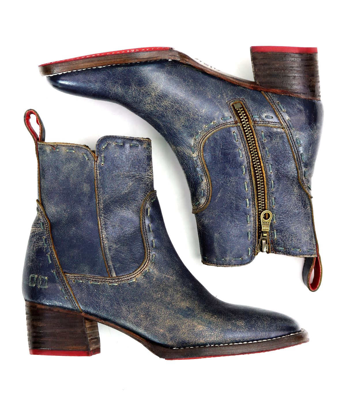 The "Merryli" ankle boots by Bed Stu, featuring worn blue leather with red tabs, side zippers, cushioned insoles, and stacked wooden heels, are showcased against a white background.
