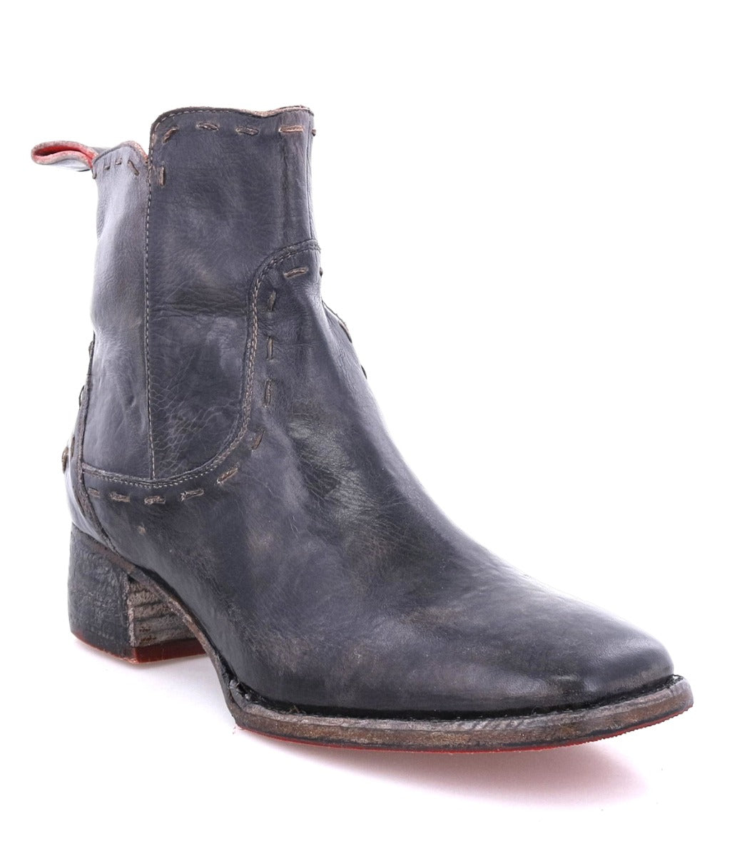 A black leather Merryli ankle boot with a red sole, by Bed Stu.