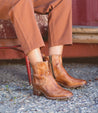 A woman wearing a pair of Bed Stu Merryli ankle boots.