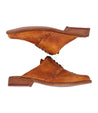 A pair of Bed Stu Mickie tan leather shoes on a white background.
