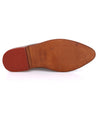A pair of Mickie shoes from Bed Stu with red soles on a white background.