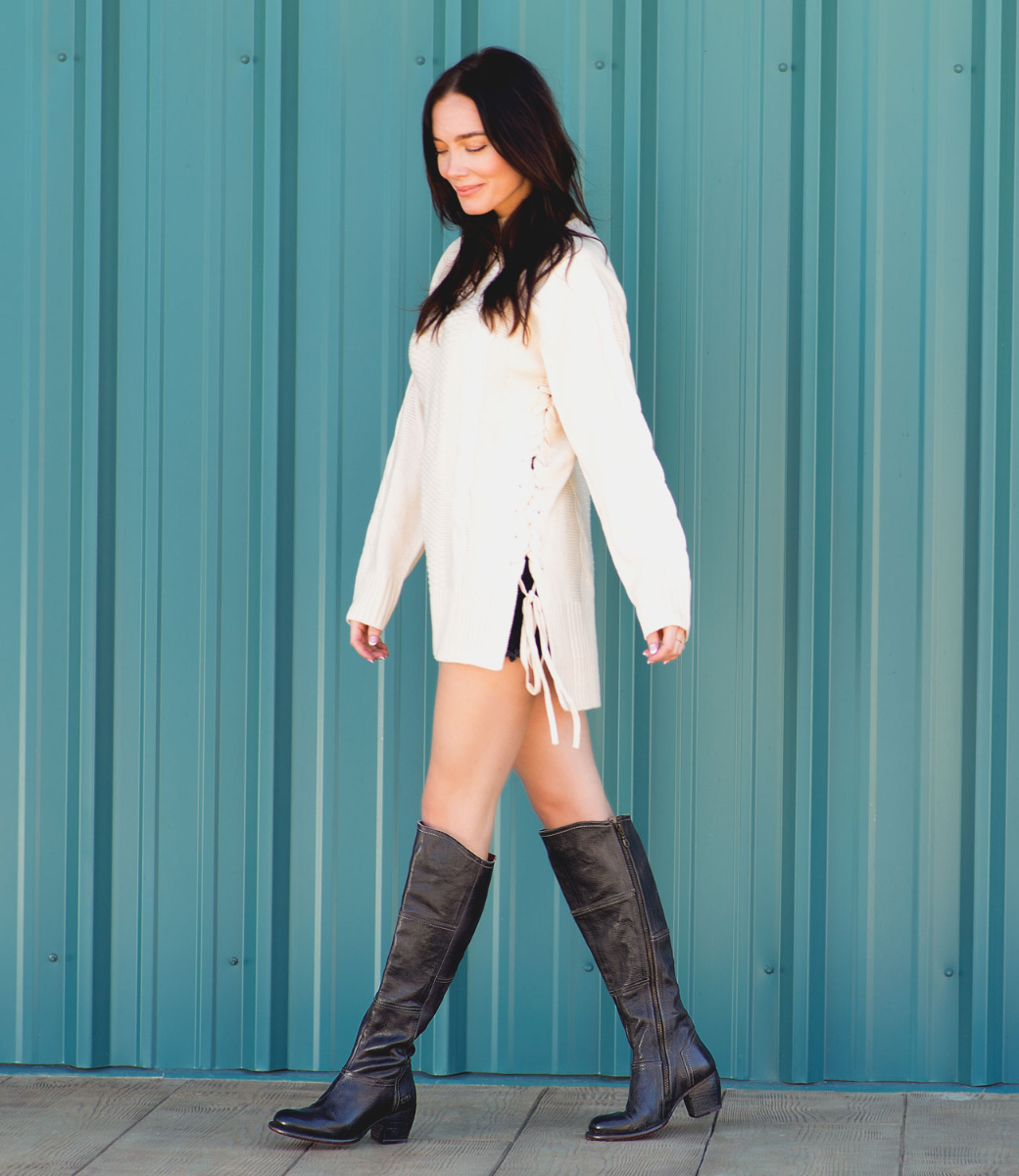 A woman in a pair of Bed Stu Kennice black leather boots.