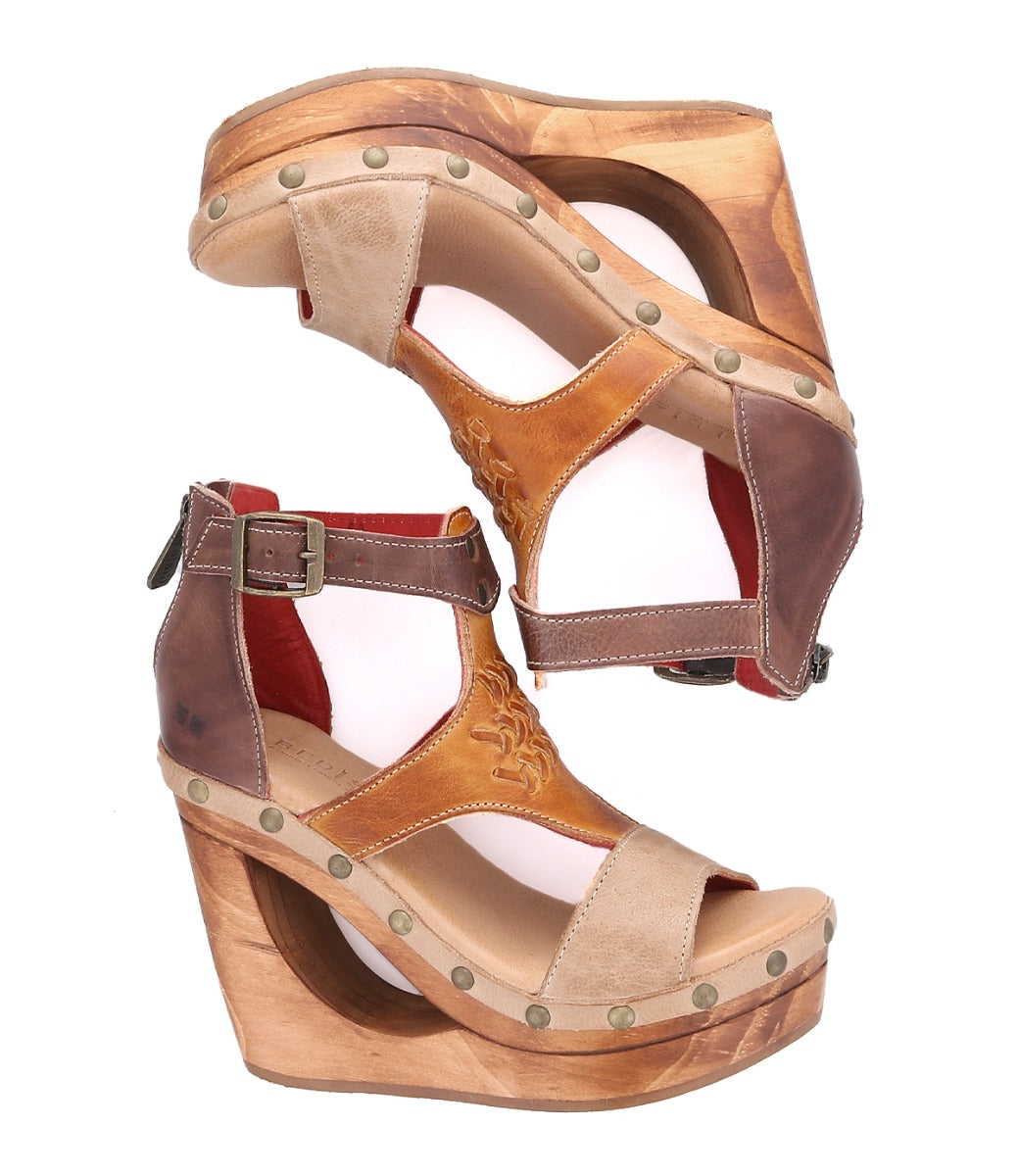 A pair of Bed Stu Millennial wooden wedge sandals with straps and buckles.