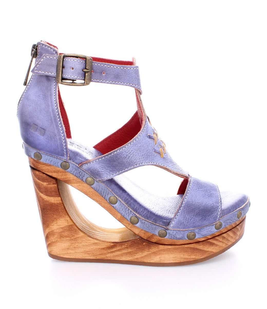 A women's blue wedge sandal with wooden platform called the Millennial by Bed Stu.