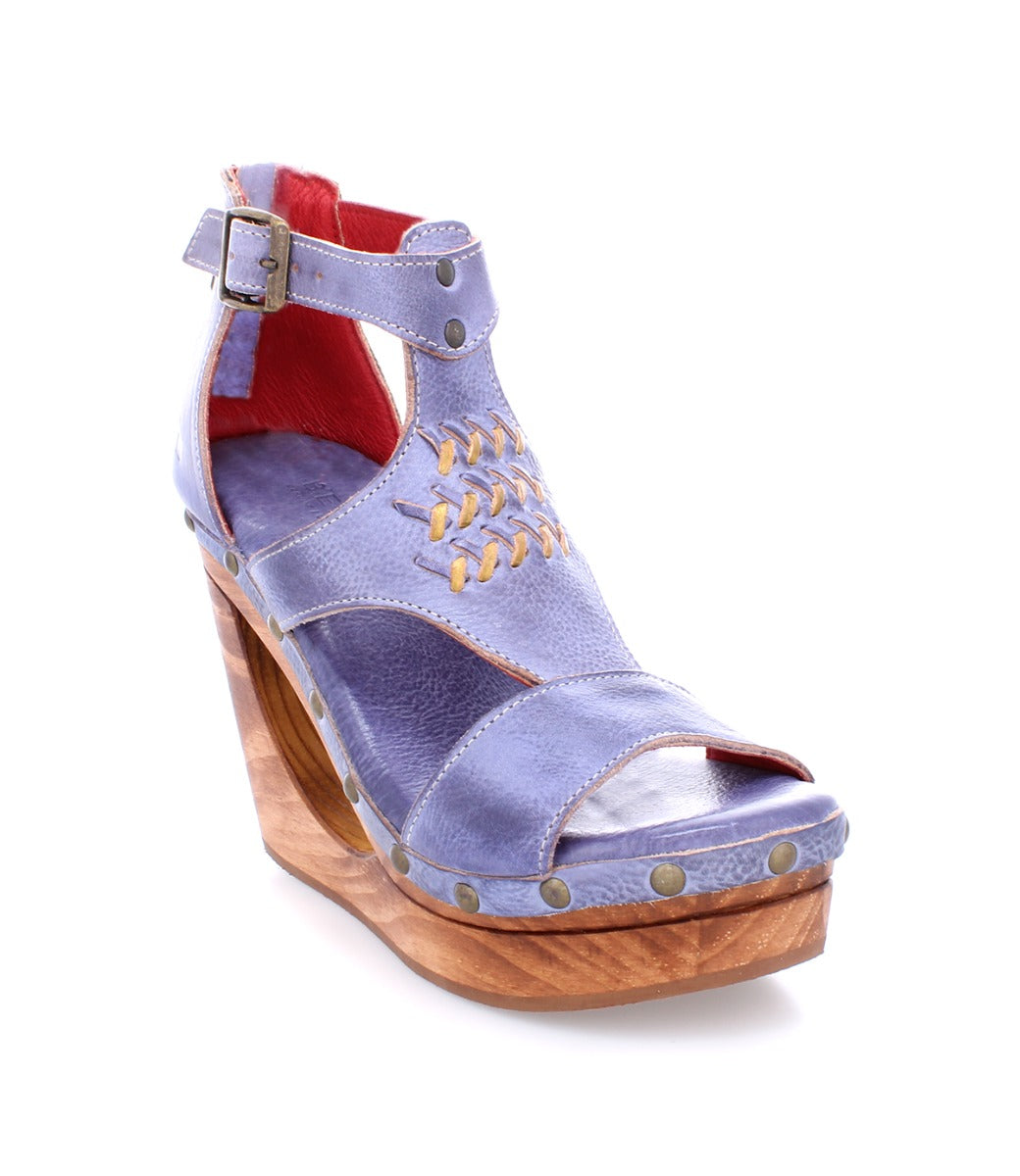 A women's blue wedge sandal with wooden platform named Millennial from the brand Bed Stu.