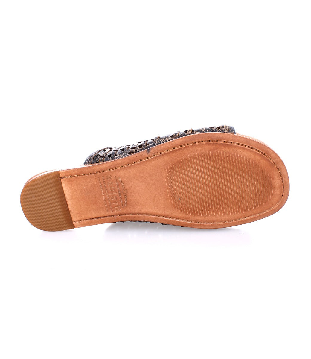 A pair of Minerva women's sandals with a brown leather sole by Bed Stu.