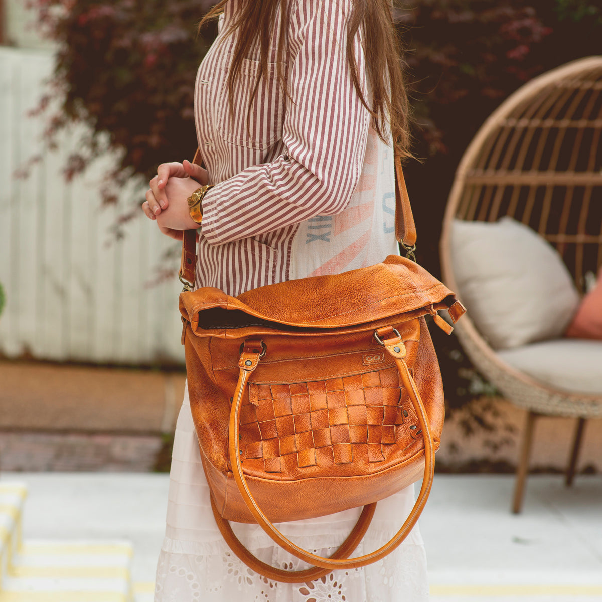 A woman wearing a Miriam handbag by Bed Stu.