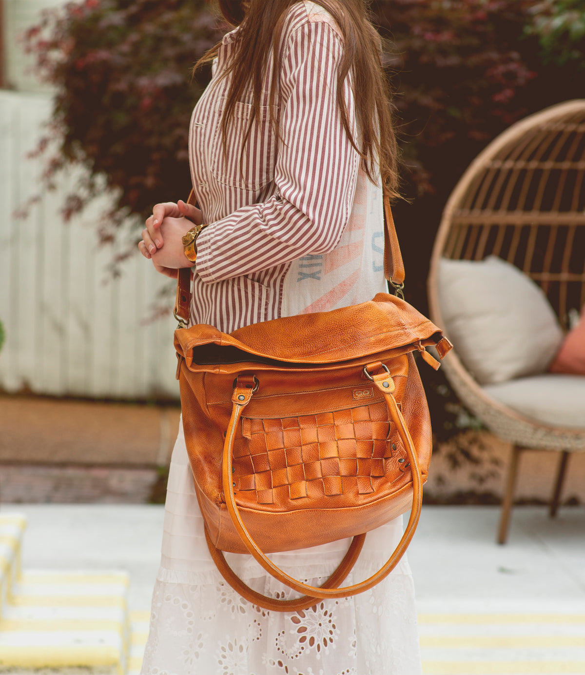 A woman wearing a Miriam handbag by Bed Stu.