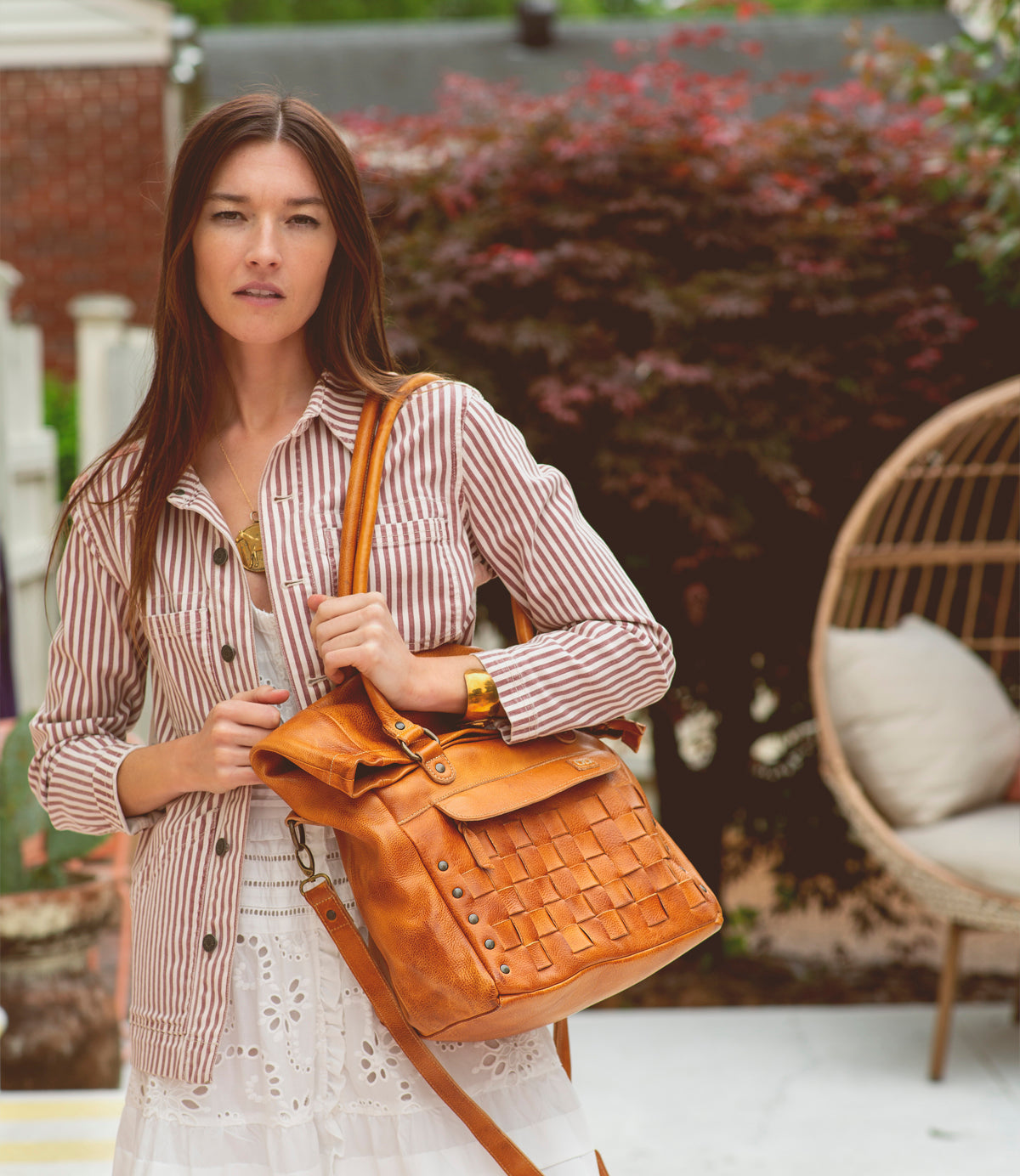 A woman wearing a Miriam handbag by Bed Stu.