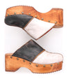 A pair of eco-friendly Bed Stu Mista wooden clogs with black and white accents.