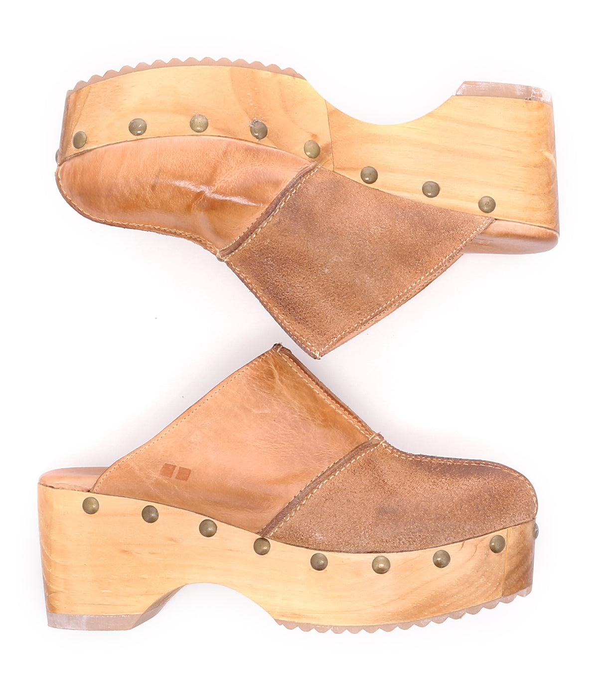 A pair of sustainable brown wood Mista clogs with rivets on the side, by Bed Stu.