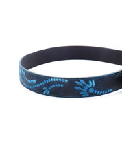 The Mohawk belt by Bed Stu is a black distressed leather accessory adorned with blue embossed floral designs and dot patterns.