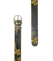 Close-up of the Bed Stu Mohawk women's distressed leather belt in dark tones, adorned with a floral design and featuring a metal buckle. The belt is displayed from the buckle end to the punched hole end.